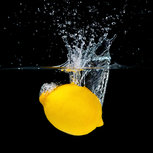 Fresh lemon falling into water Fresh lemon falling into water